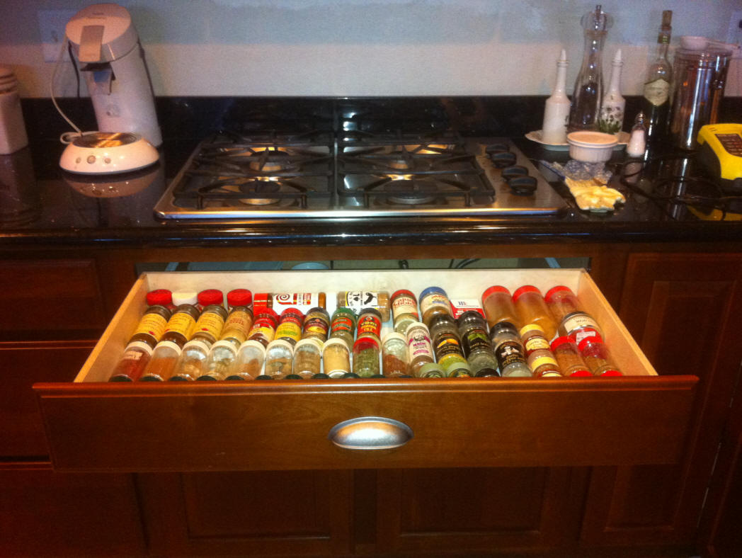 Pull out shelf used as a spice drawer under range
